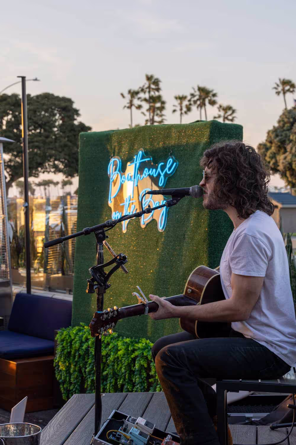 Live musician performing on the Boathouse patio